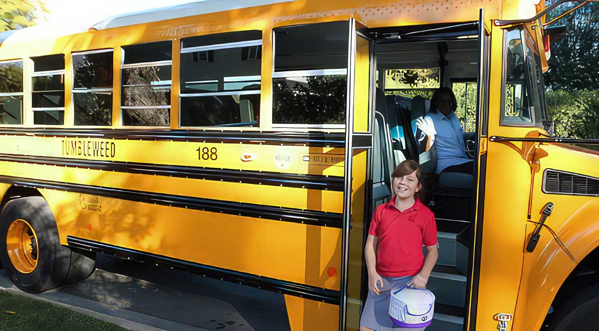 Image of Tumbleweed Bus and kid at door